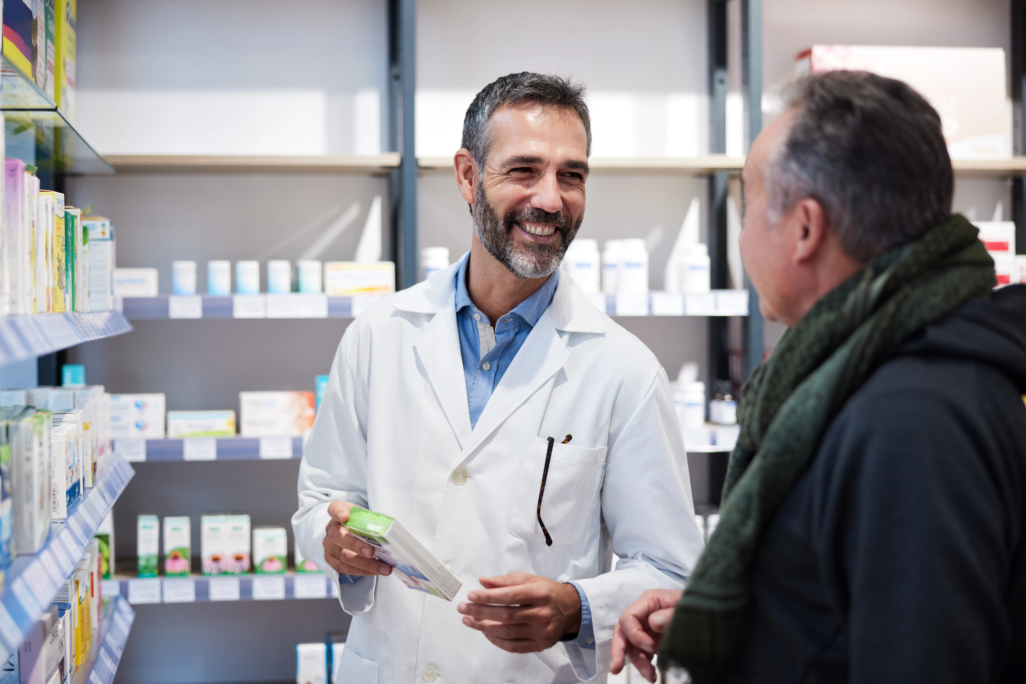 Pharmacist helping a senior man.
