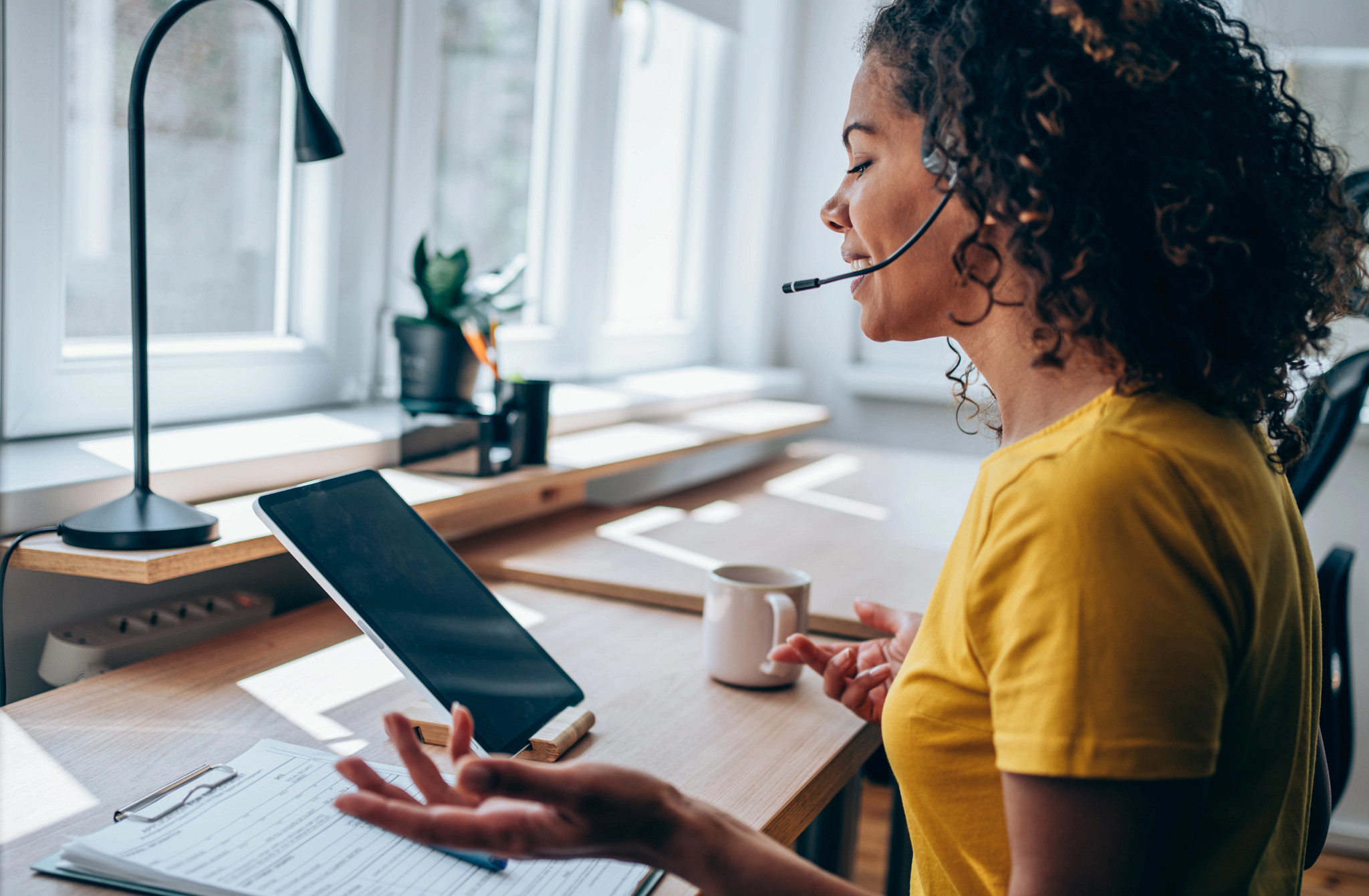 Hotline staff member using tablet and headset