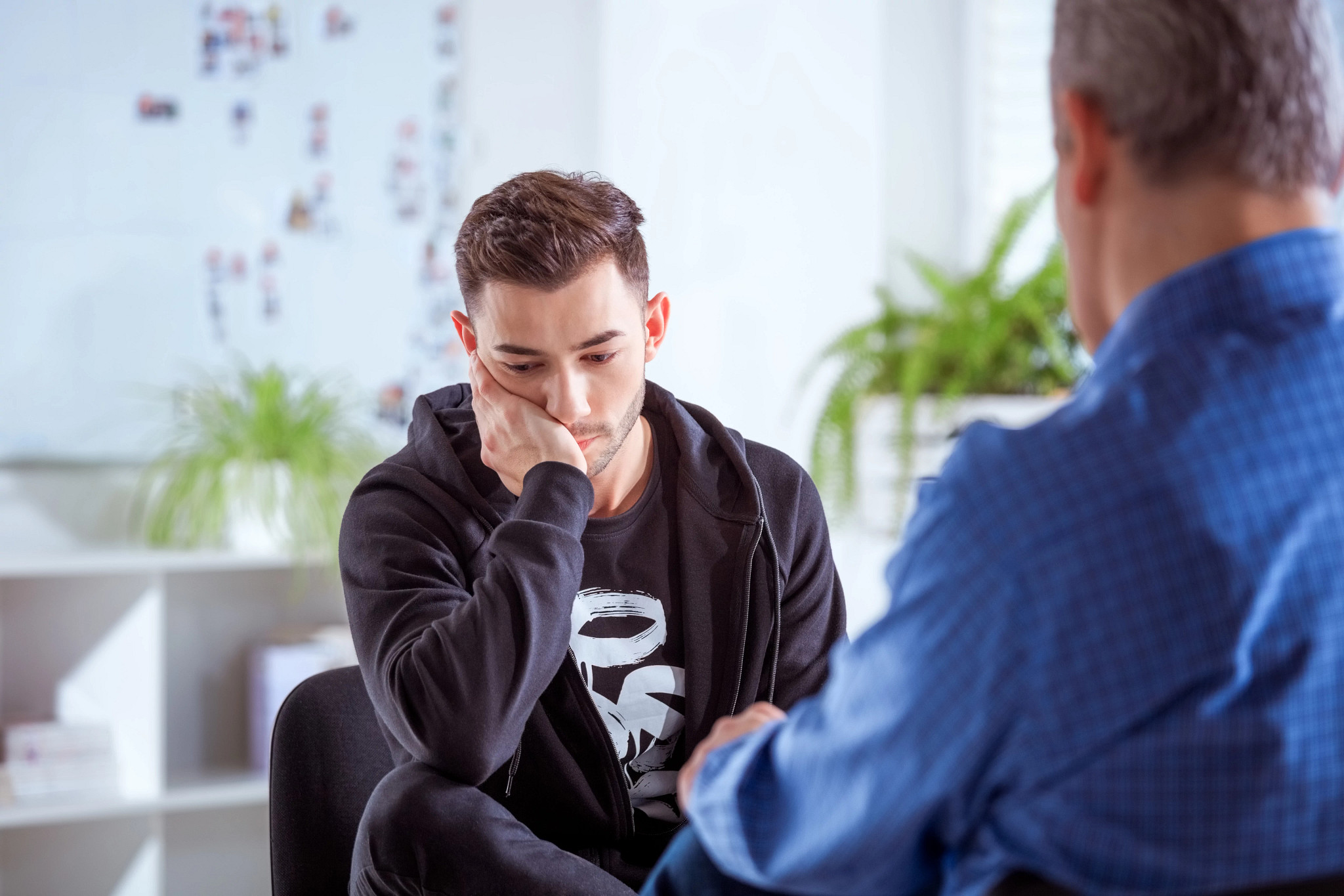Sad student talking with therapist
