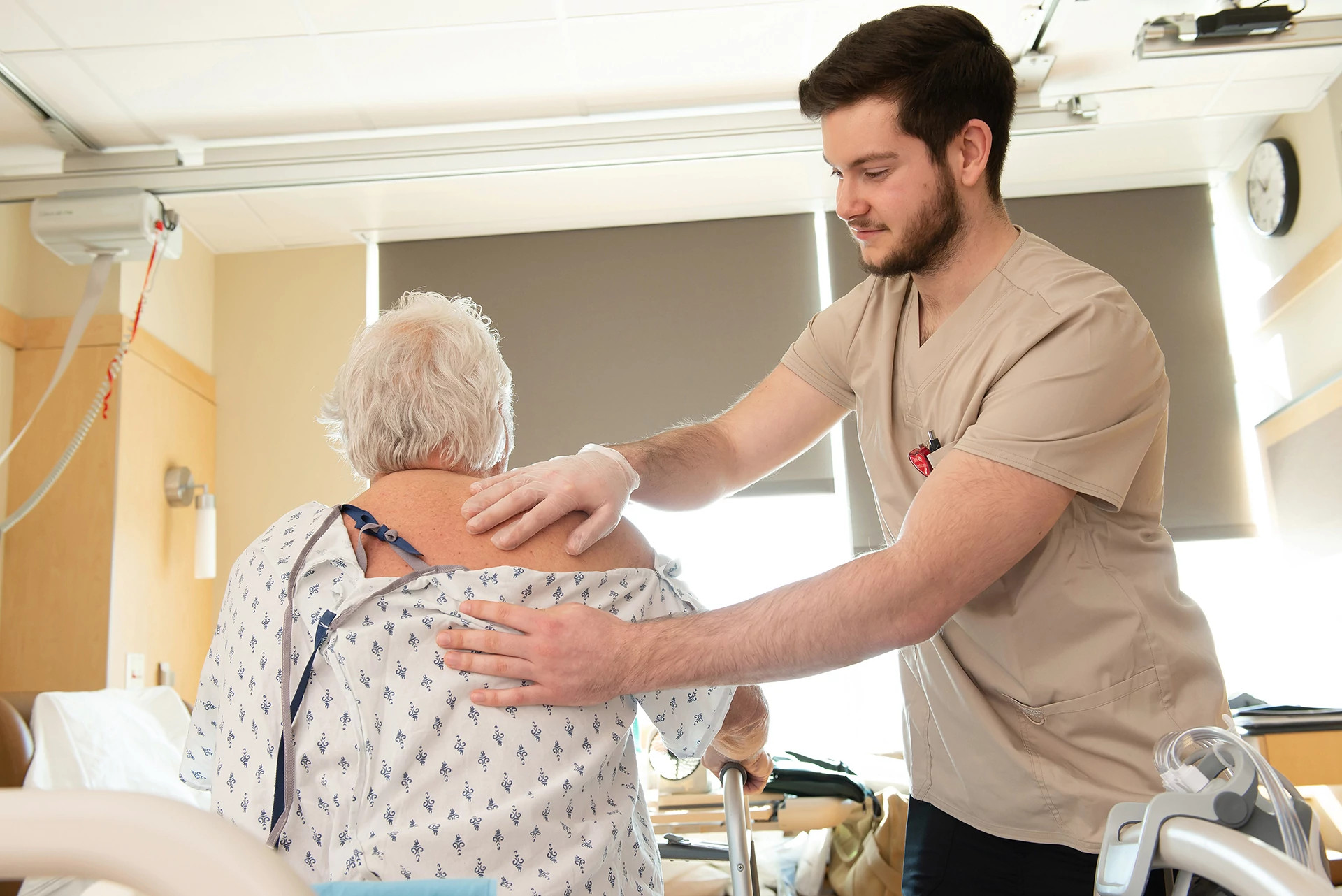 nursing-assistant-applying-essential-oils-to-patient