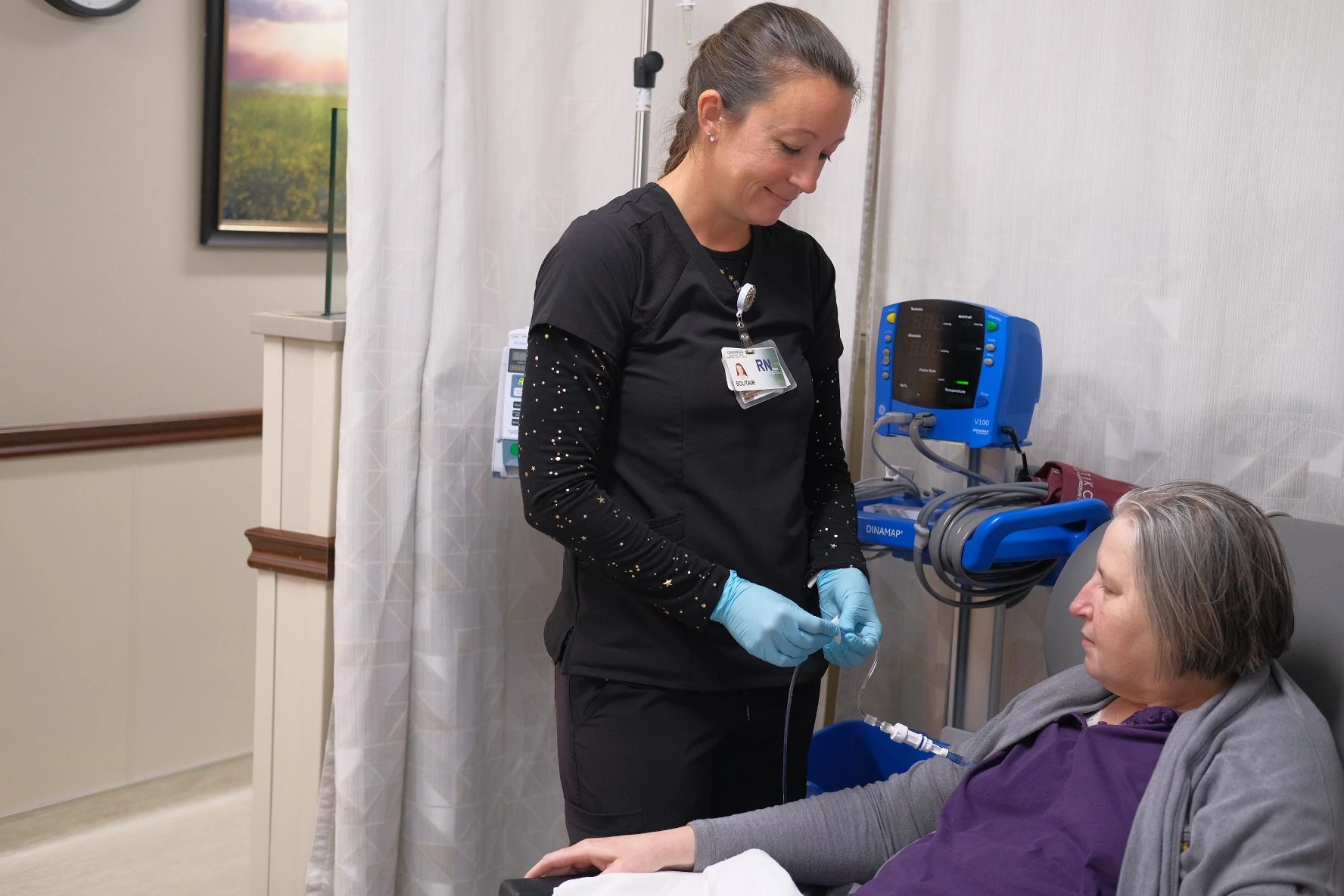 Nurse caring for patients IV in Infusion Center.
