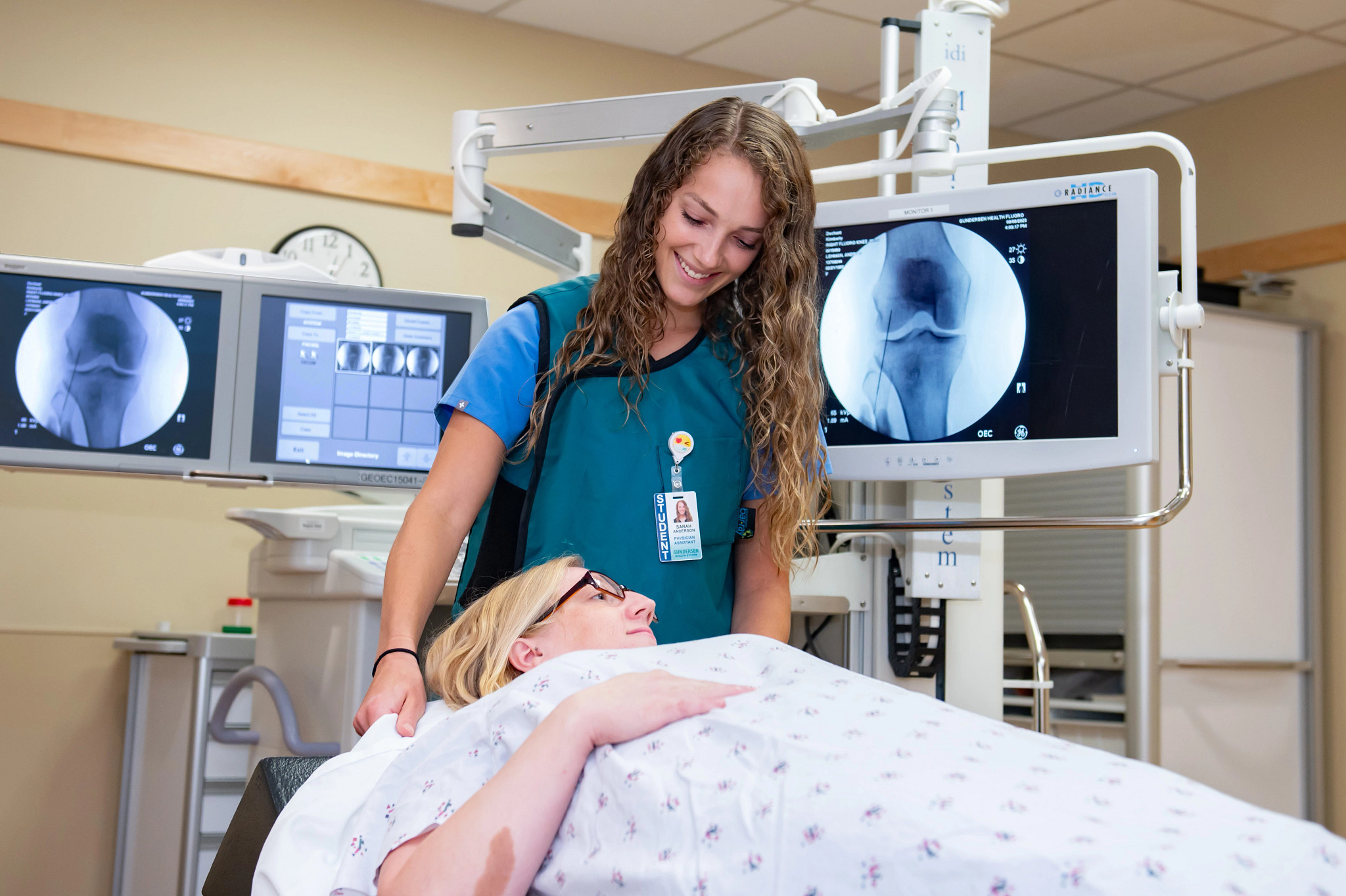 Physician assistant student helping patient through imaging procedure.