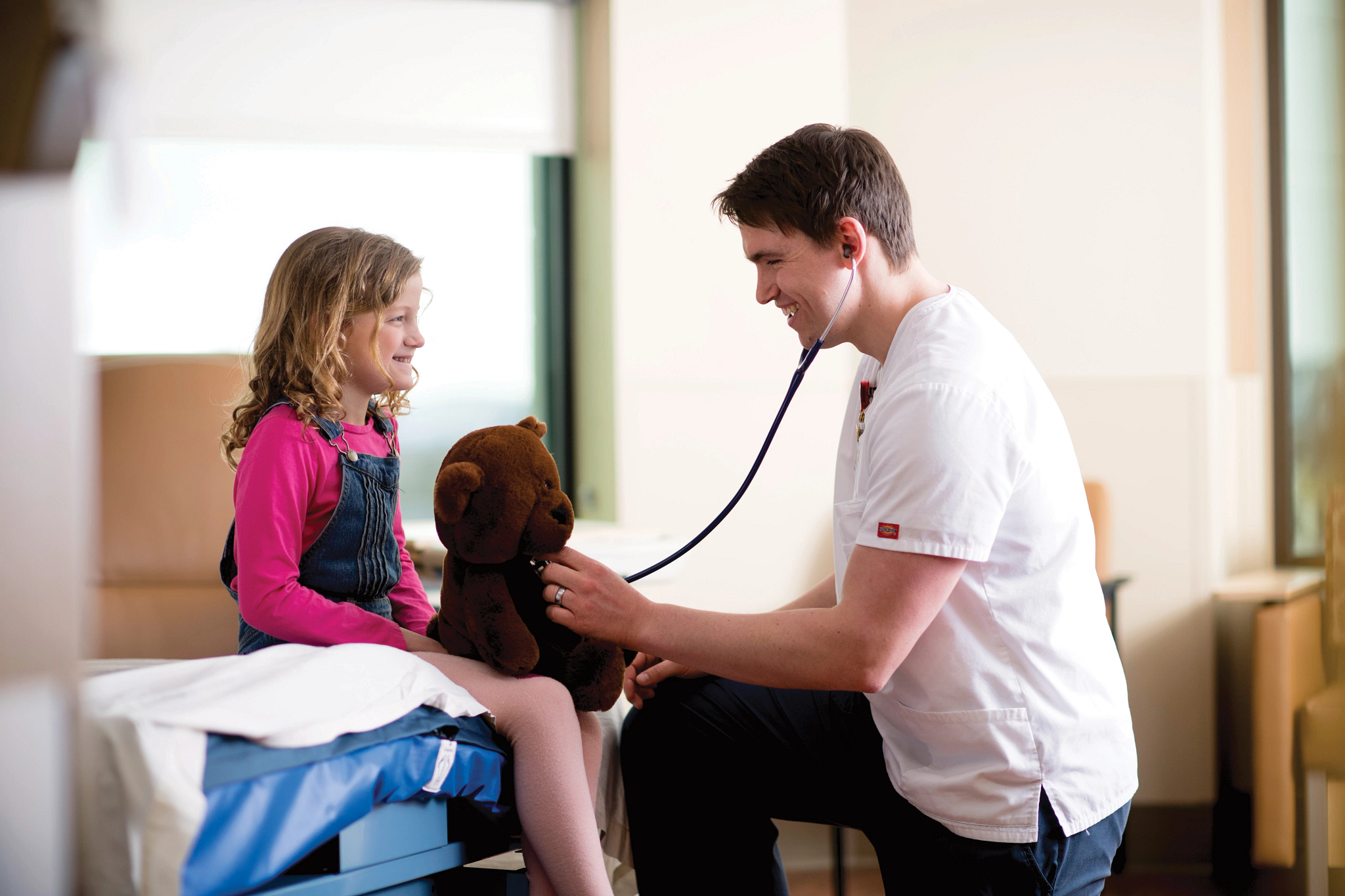 RN-caring-for-child-and-teddy-bear