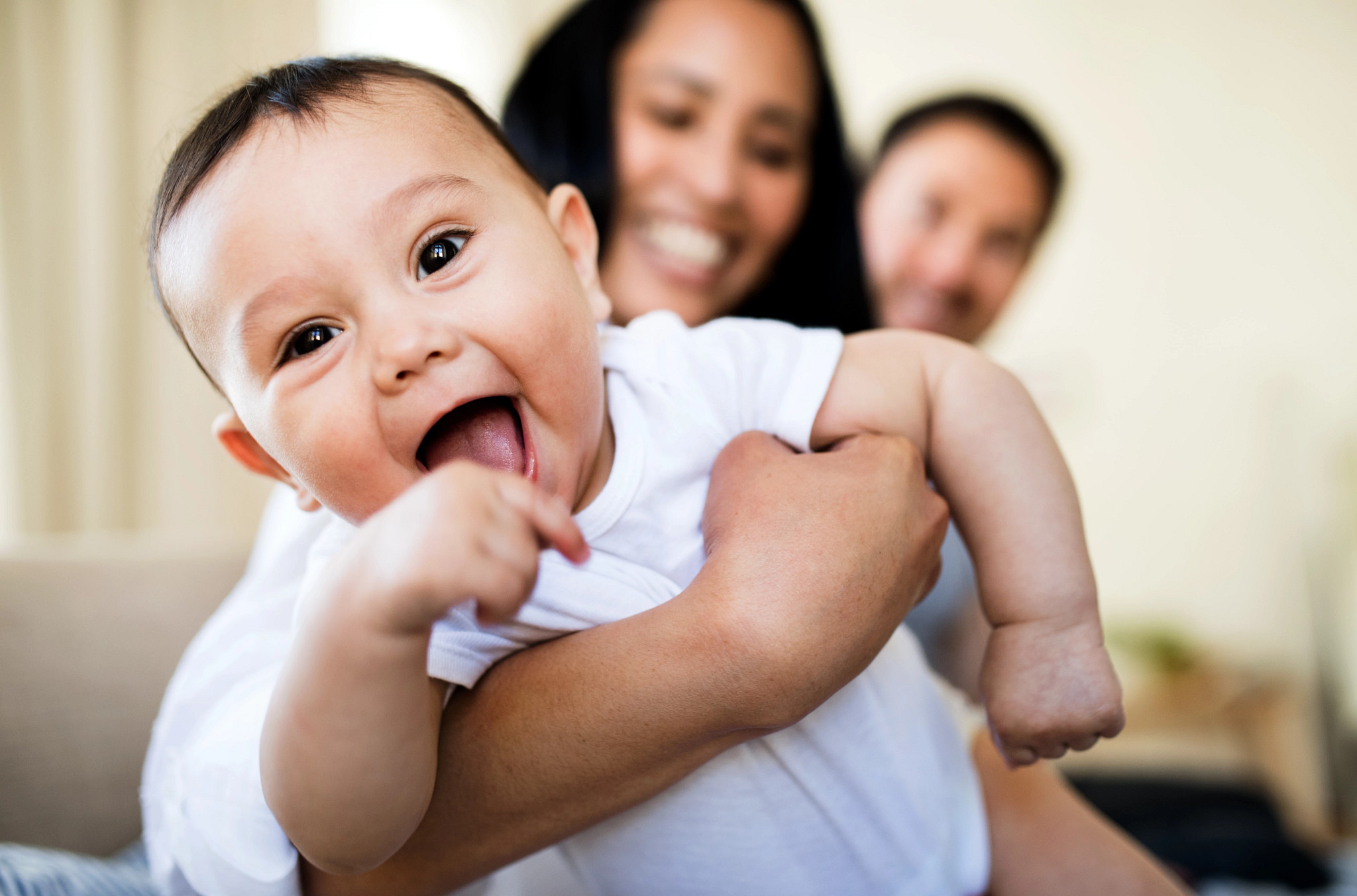 A young mother and father spending time together with their son indoors.