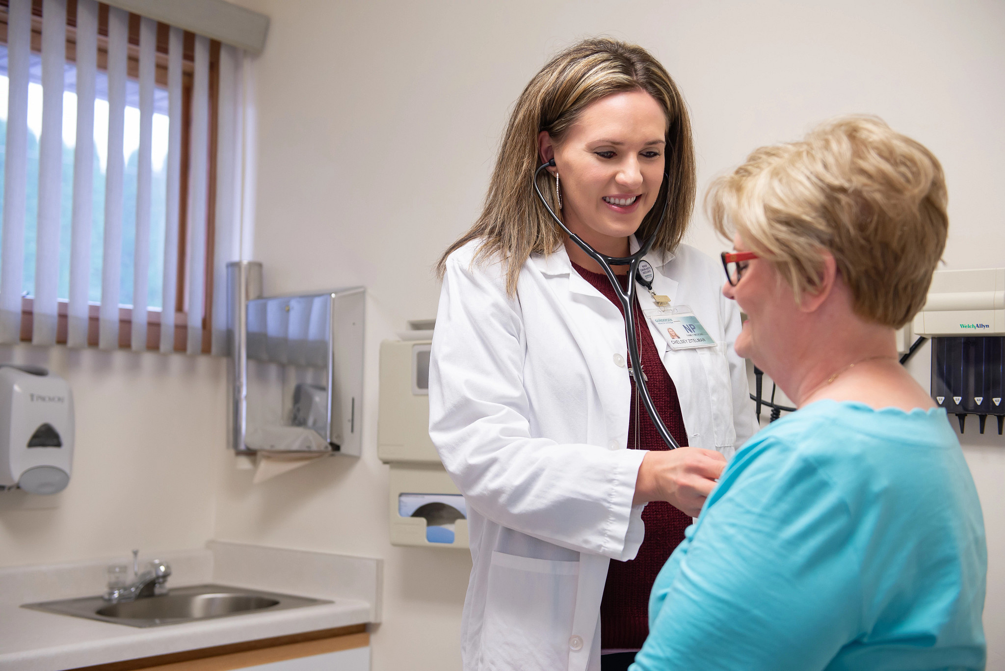 Nurse checking female patients heartbeat.