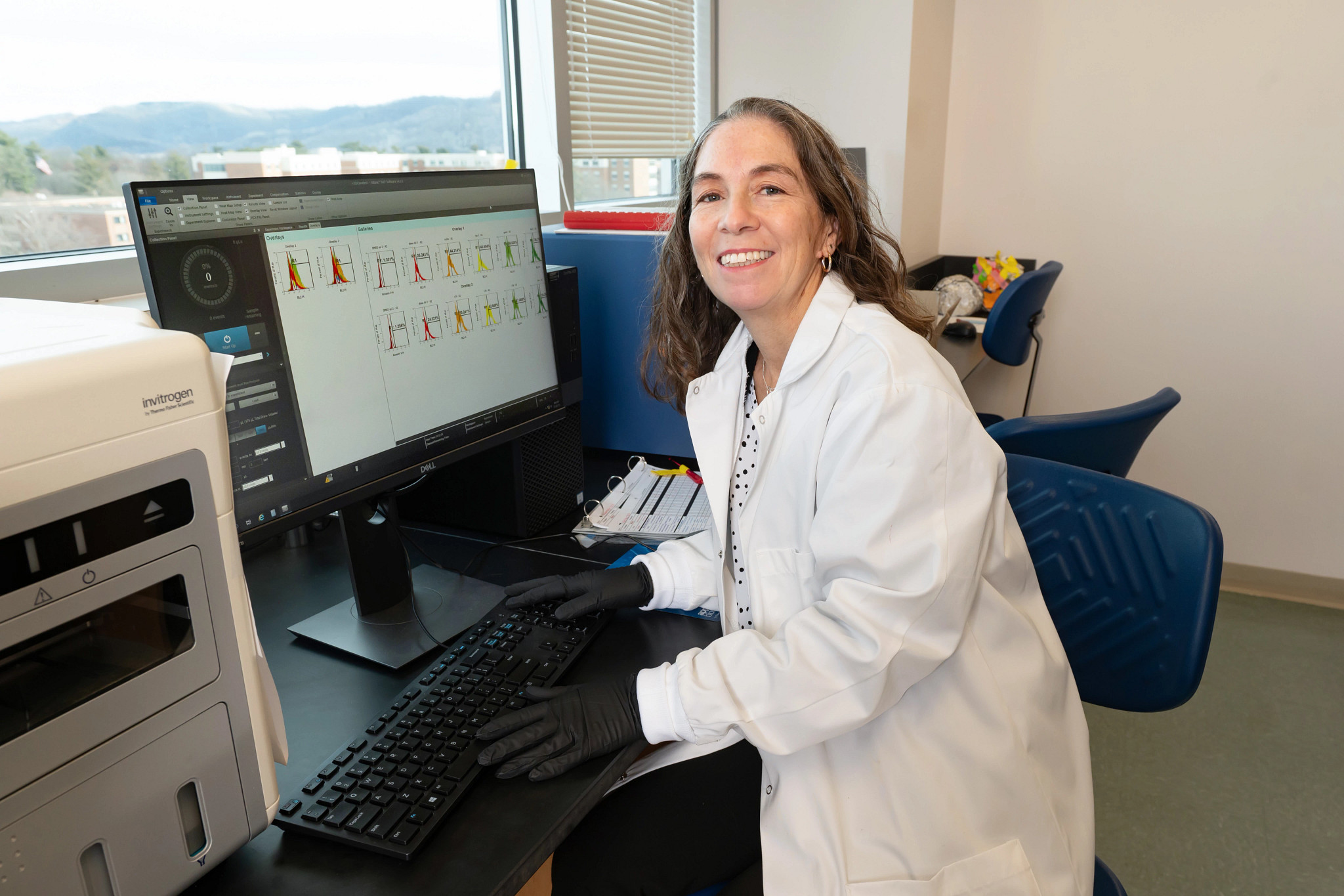 Karen Cowden Dahl ovarian cancer researcher at lab computer.