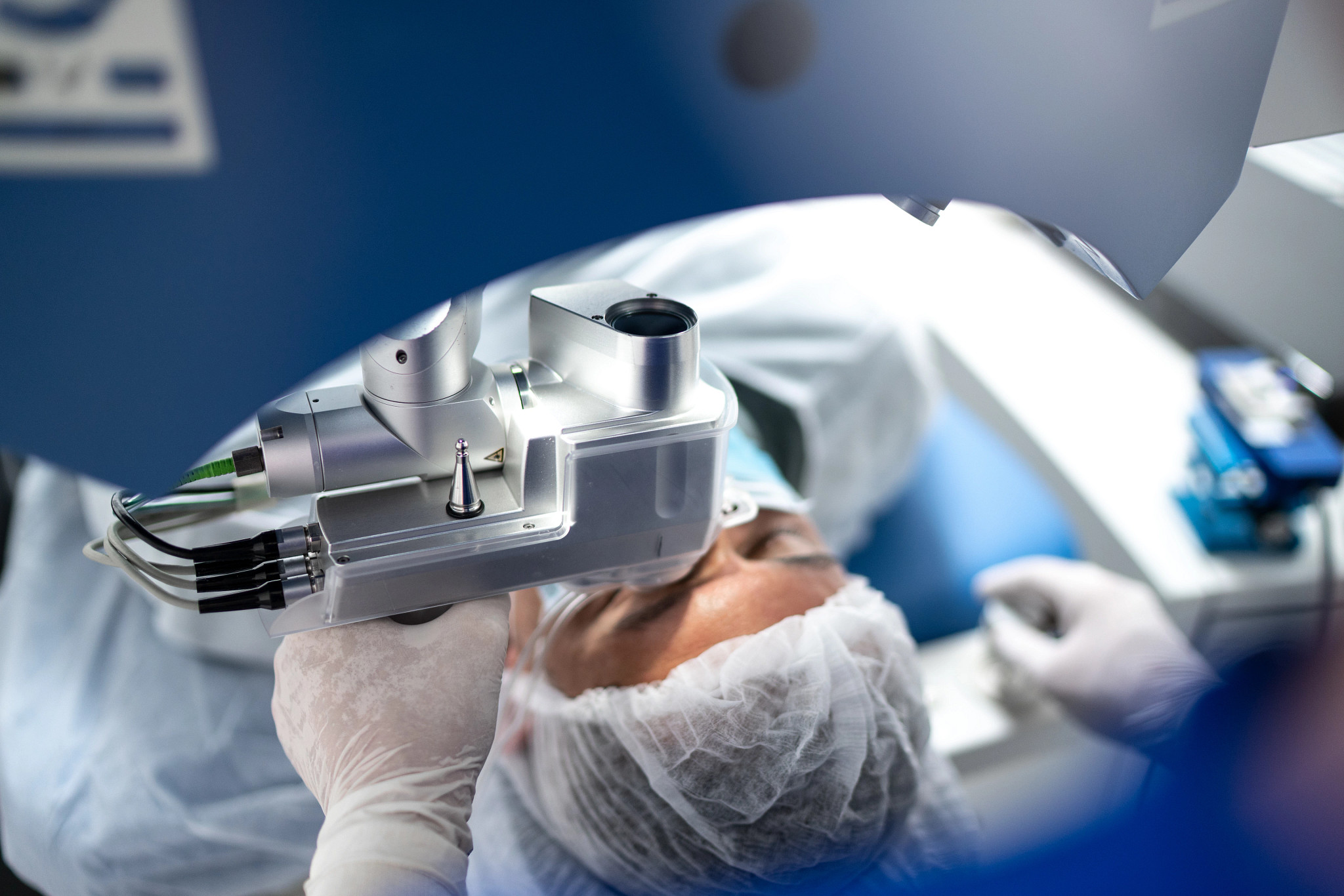 Patient on exam table getting eye surgery.