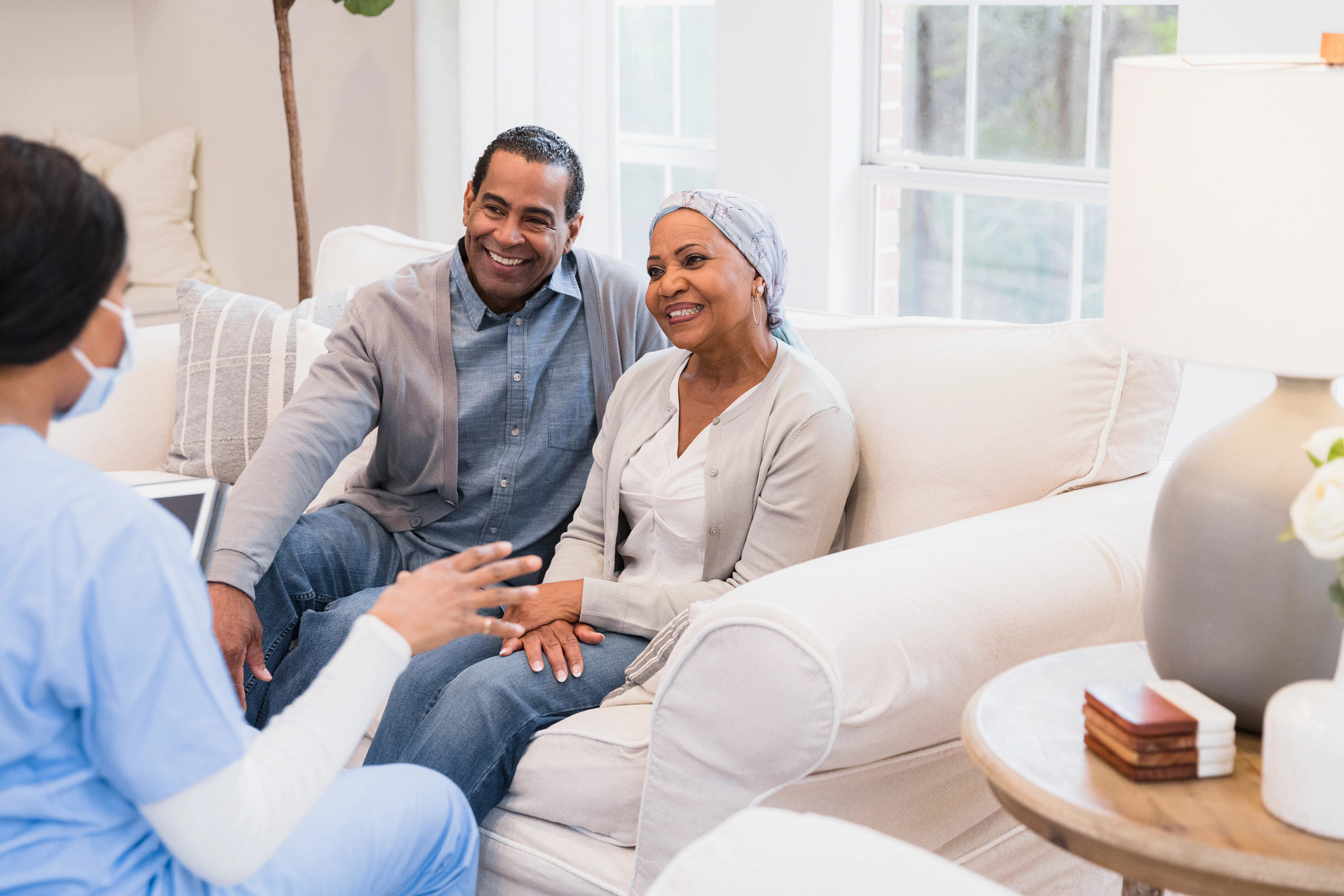 Husband and wife sit and talk to the nurse