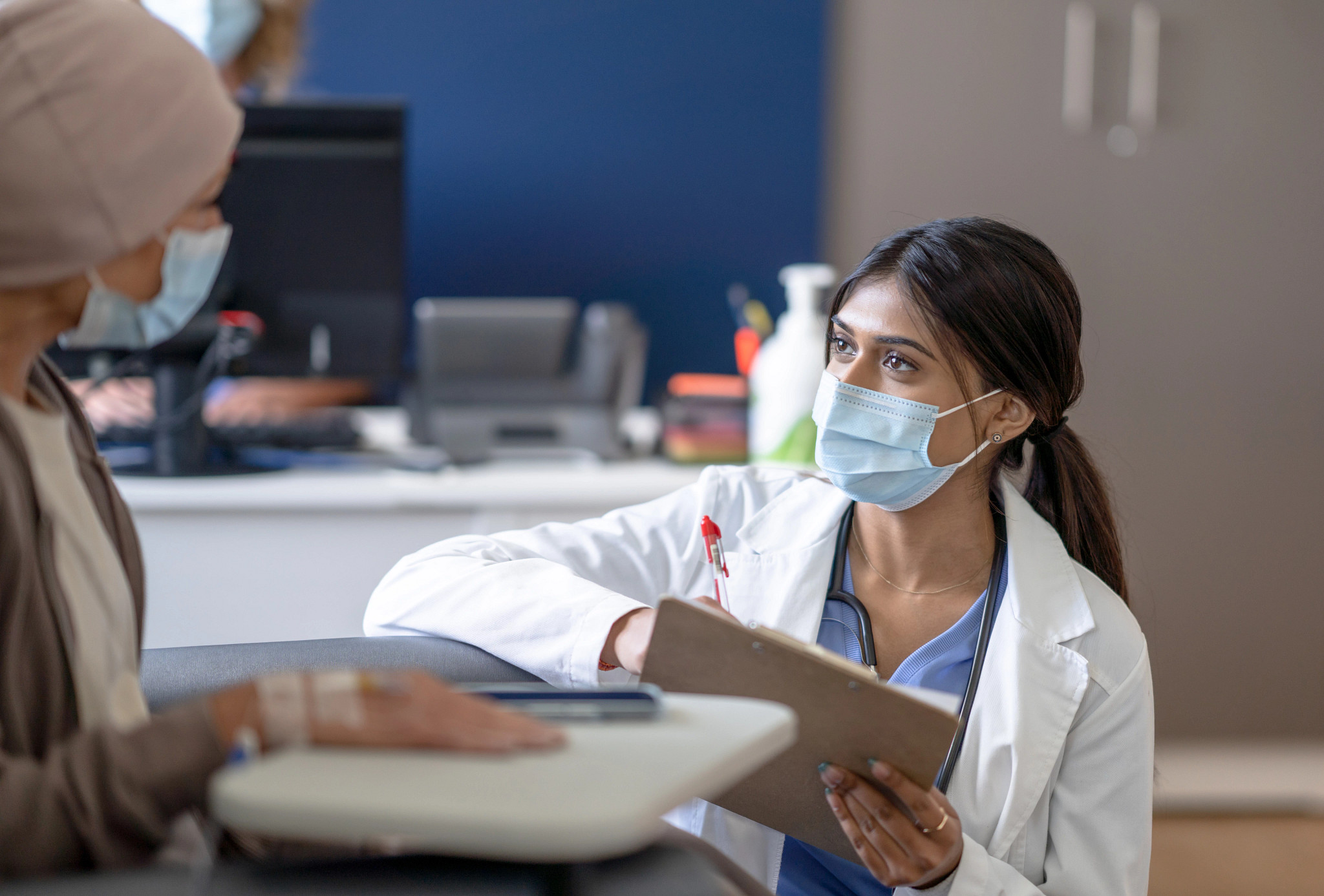Female doctor listening to patient with cancer.