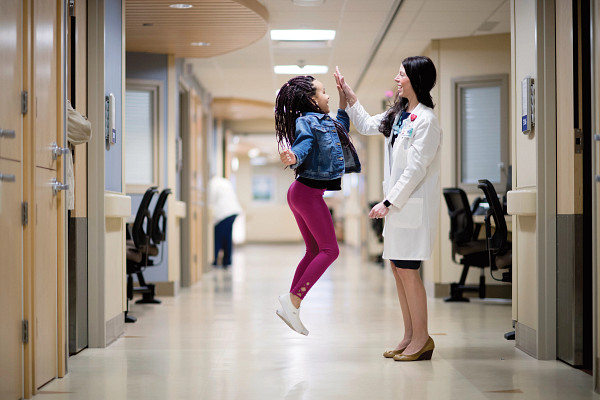Stepanie-Neuman-MD-high-five-with-child.jpg