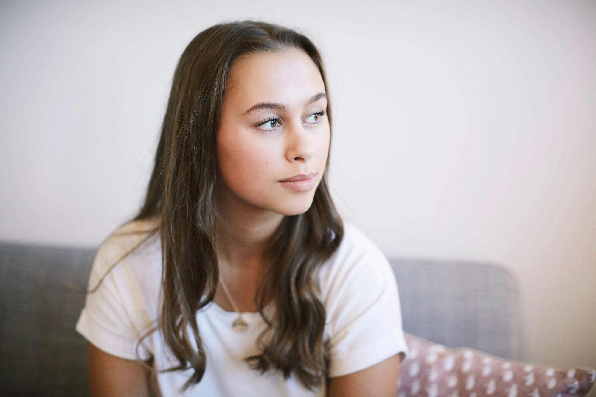 Thoughtful-teenage-girl-sitting-at-wellness-center-GettyImages-1171809599.jpg