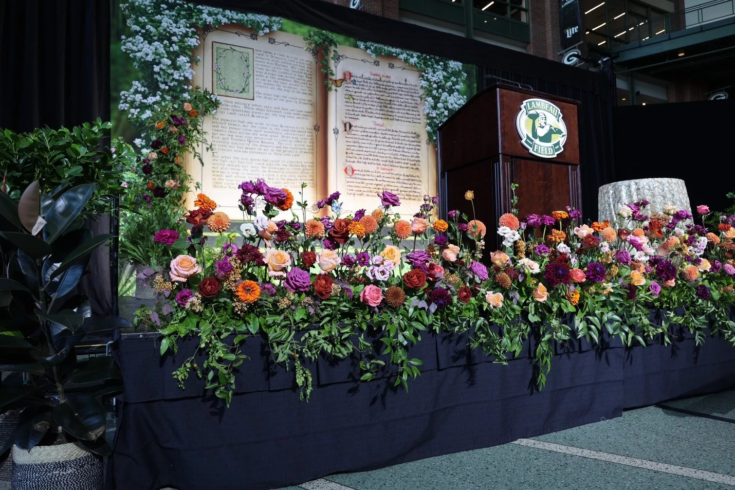 Flowers decorating the stage at Black Tie & Blue Jean Extravaganza