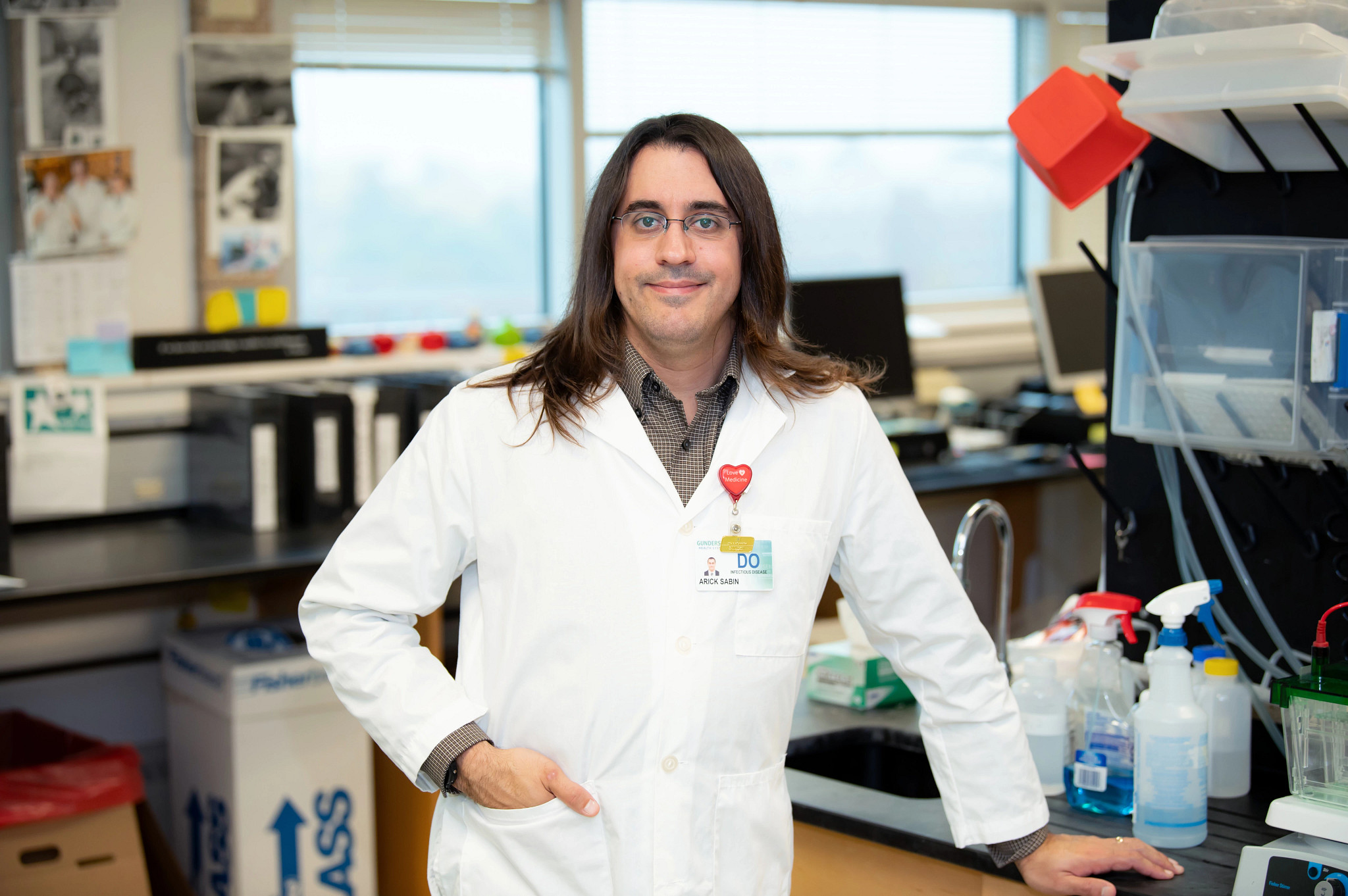 Lyme disease researcher Arick Sabin in white coat at research lab.jpg