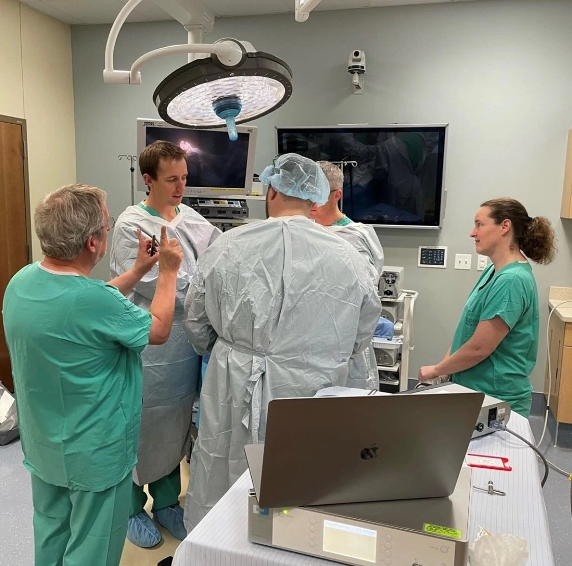 Students learning in mock surgical room.
