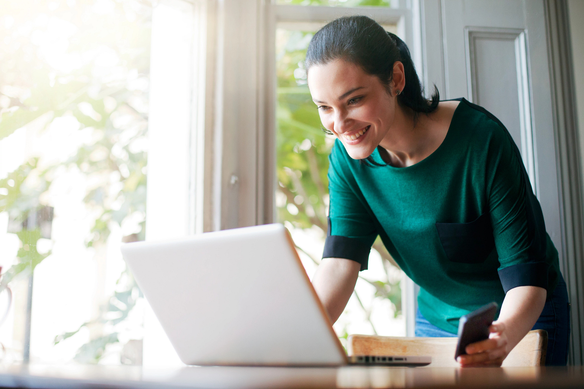 Woman smiling at laptop