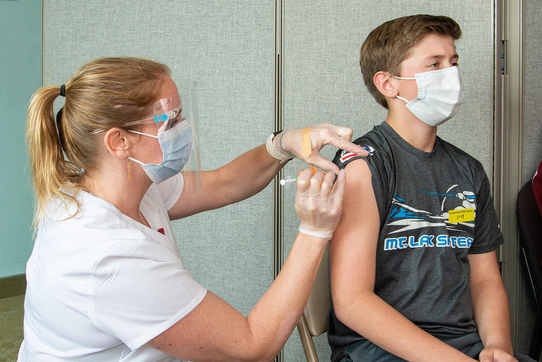 Young boy getting vaccine.