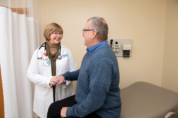 Gundersen Tri-County nurse practitioner caring for adult male in exam room.