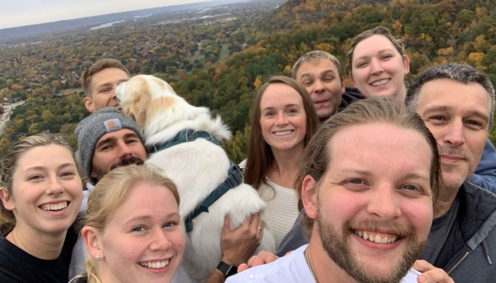 Residents and dog hiking on bluff.