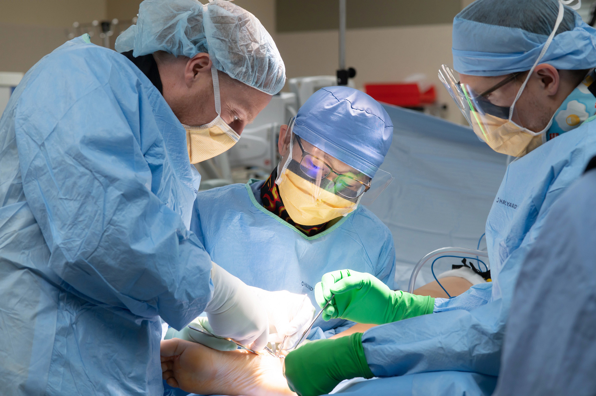 Podiatry residents operating on a foot.