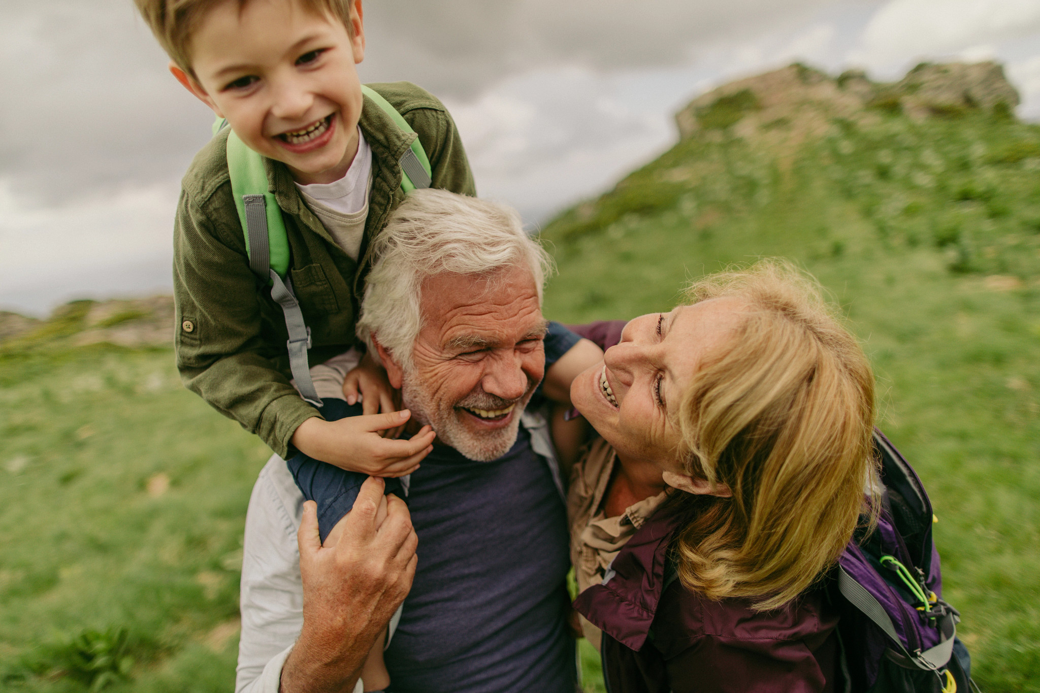 Grandson hiking with grandparents.