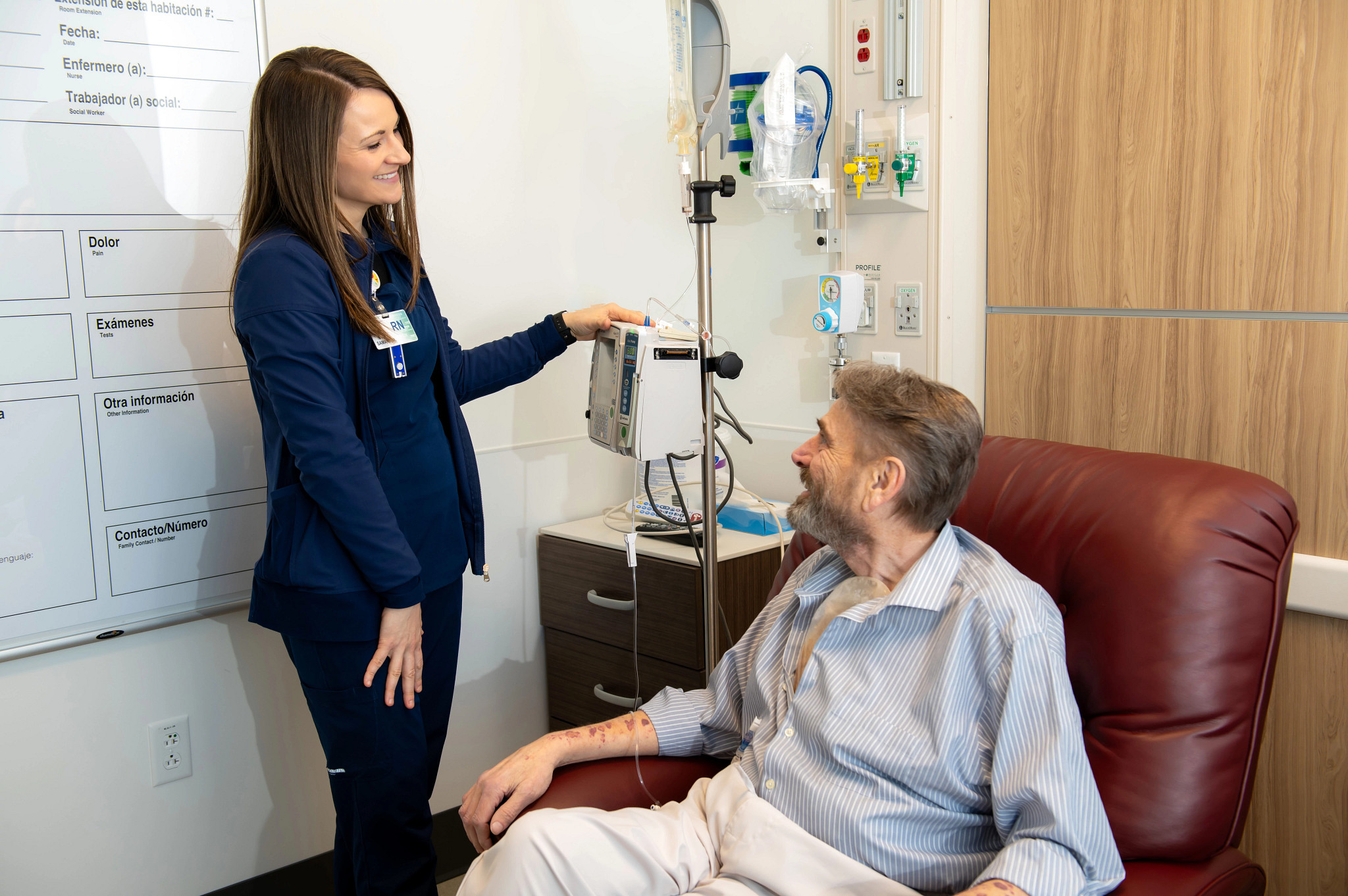 Gundersen Tri-County registered nurse helping patient in hospital room.