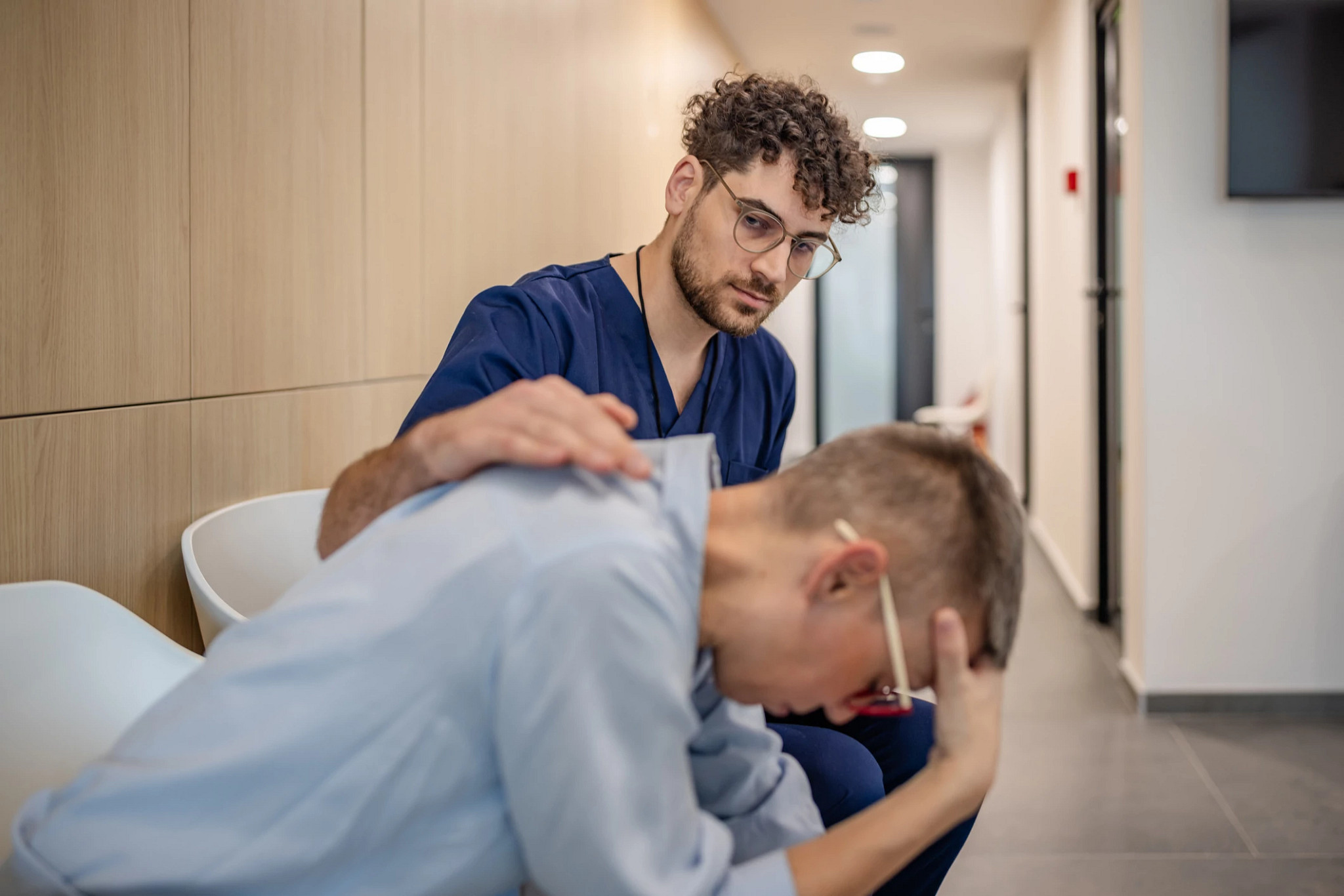 Provider reassures patient in a healthcare setting.