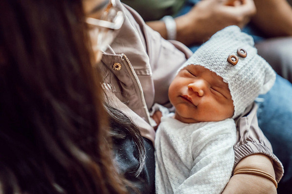Mother holding her newborn child in hospital.