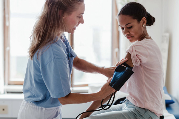 gettyimages-1188431897_mature-nurse-checking-patients-blood-pressure-in-office.jpg