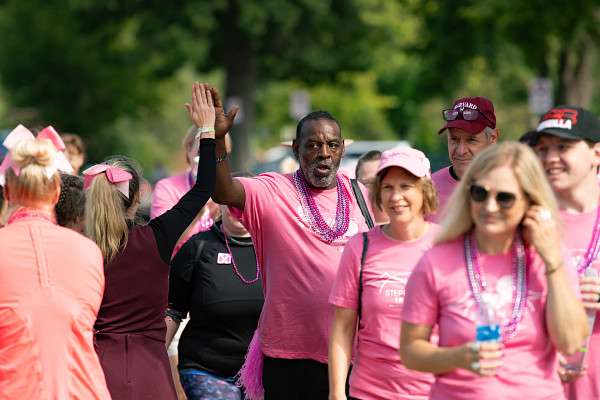 Man and woman exchanging high fives at fundraising event.