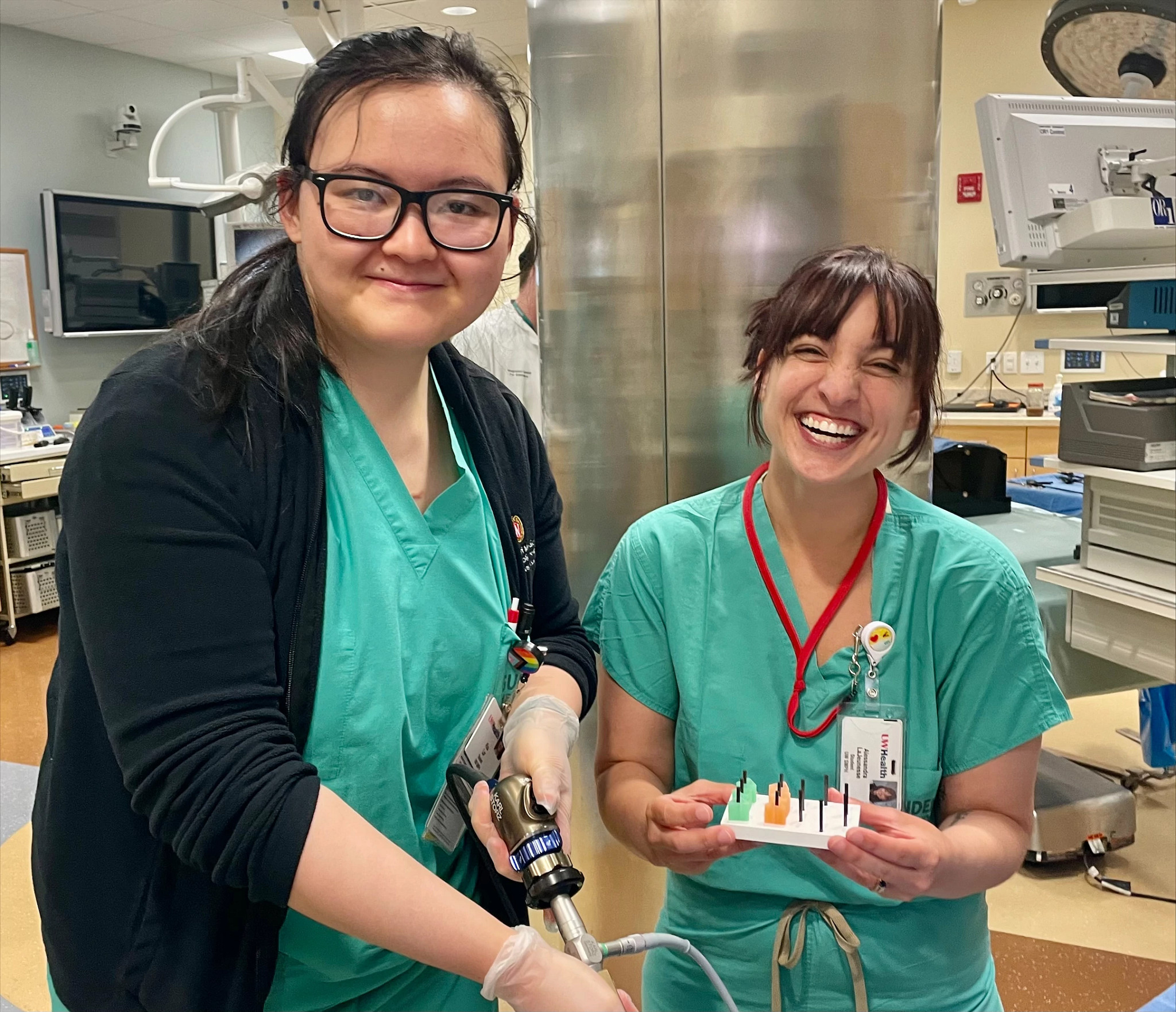 Medical students smiling in simulation lab.