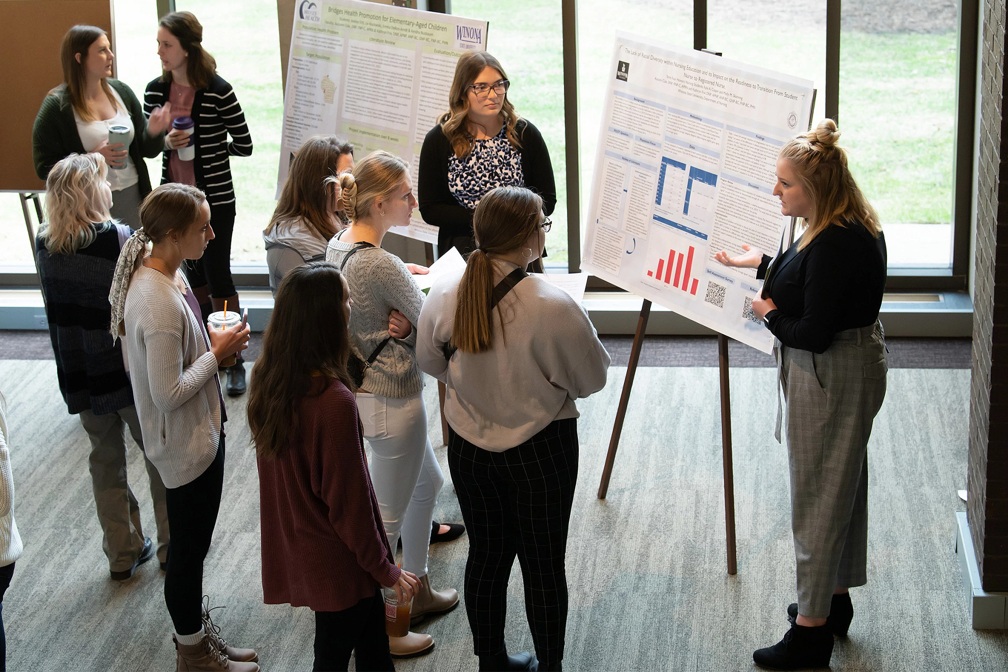 Group of women listening to research presenter.