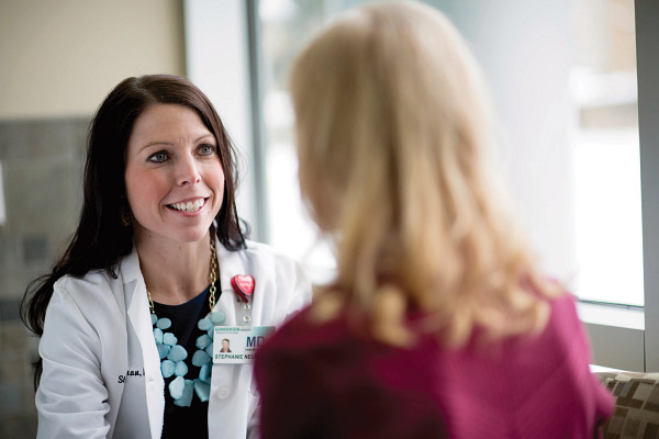 Female doctor talking with female patient.