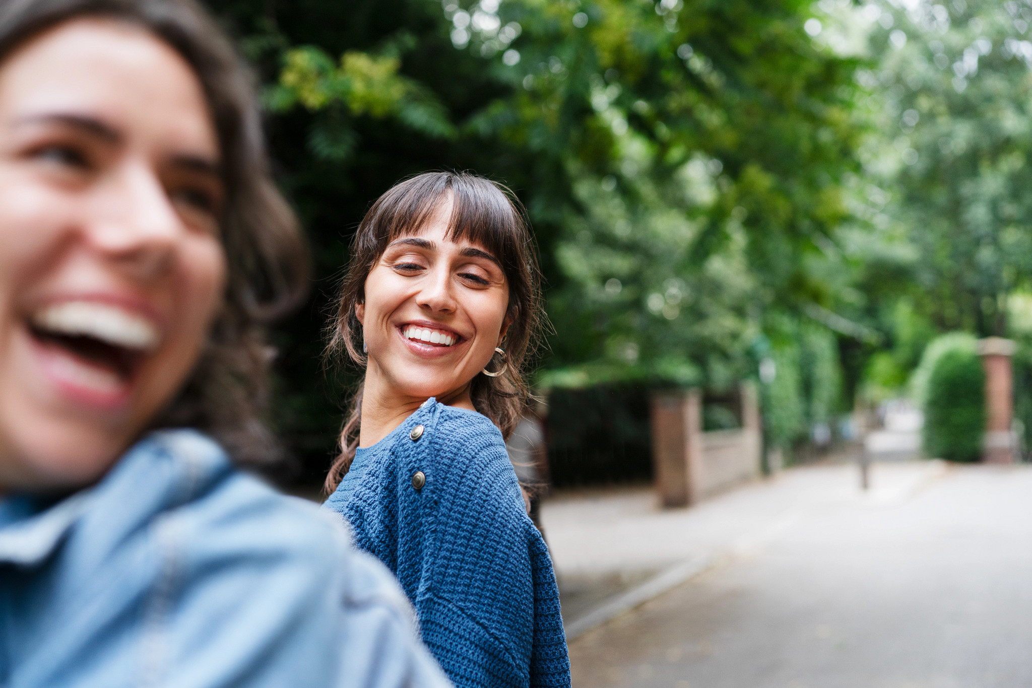 Two women laughing together being playful