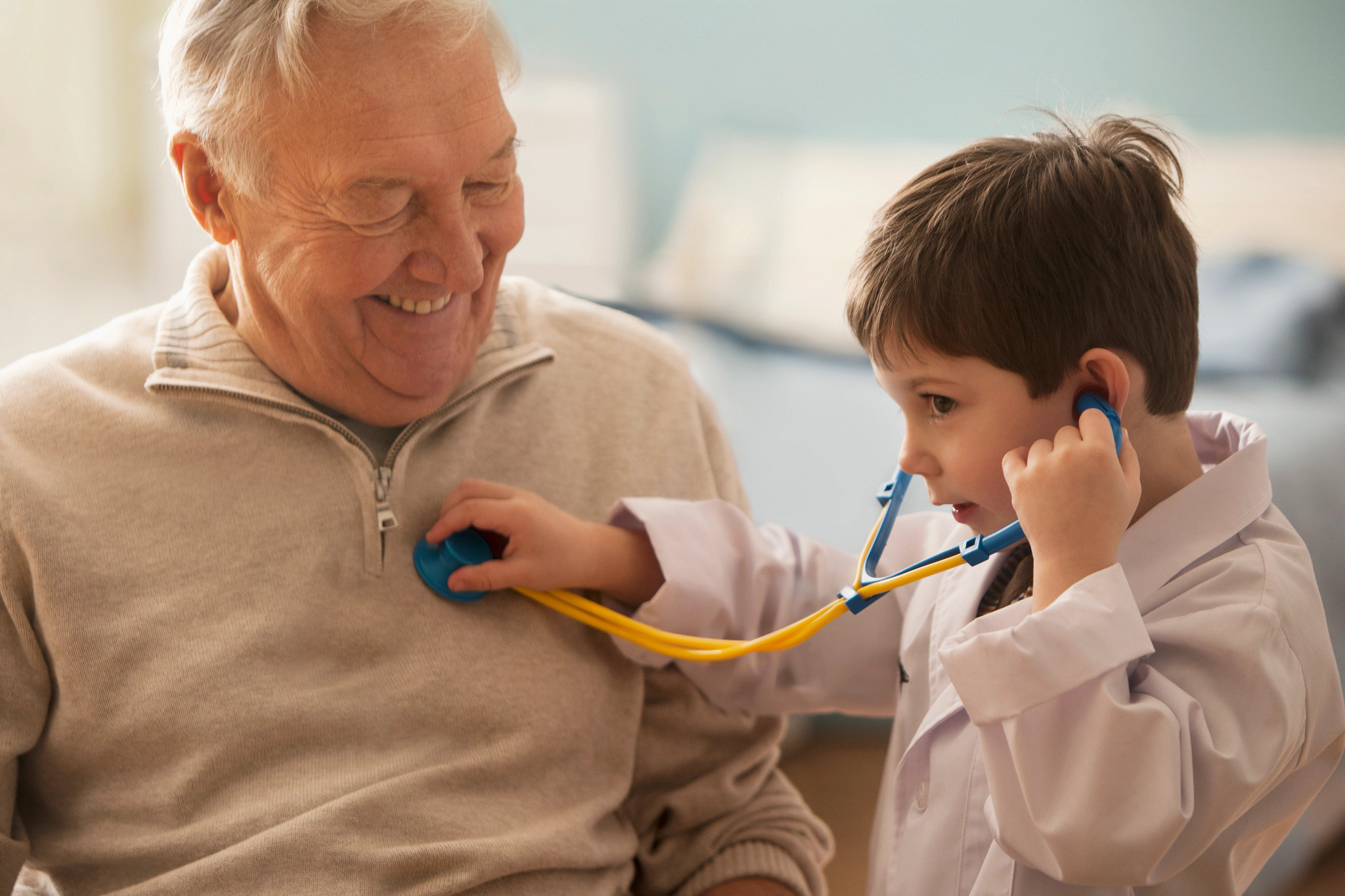 gettyimages-148194849_toddler-boy-listening-to-grandfathers-heartbeat-with-toy.jpg