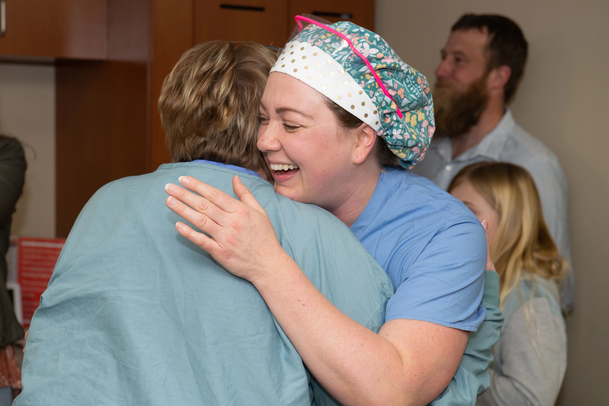 nurse-excellence-winner-hugs-coworker-with-big-smile.jpg