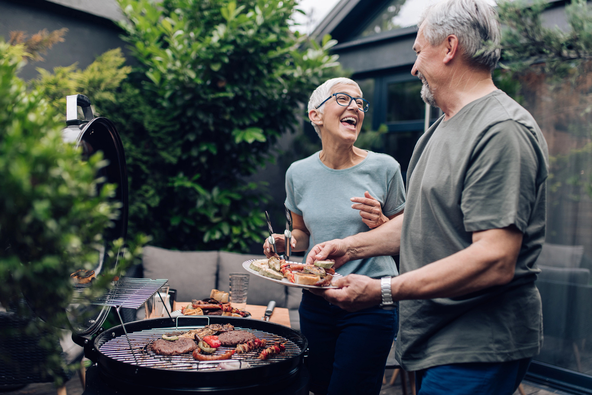 Senior couple preparing barbecue