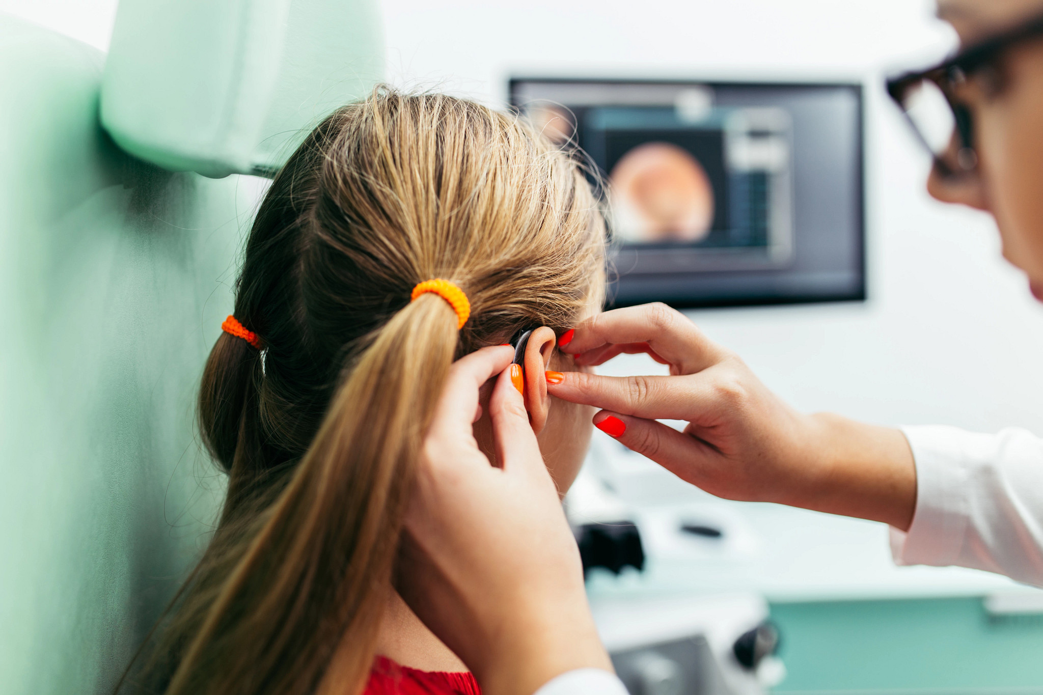 Young girl at a hearing aid checkup