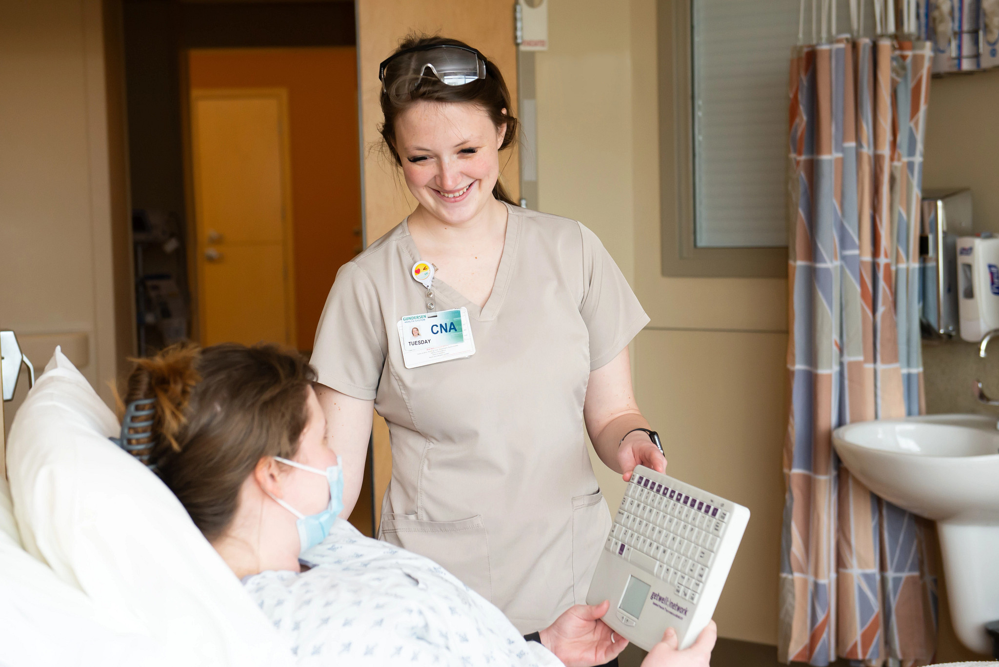 cna-caring-for-patient-in-hospital-room