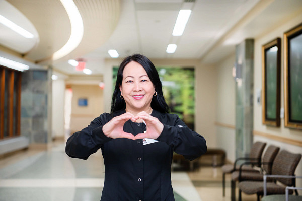 woman-with-her-hands-in-heart-shape