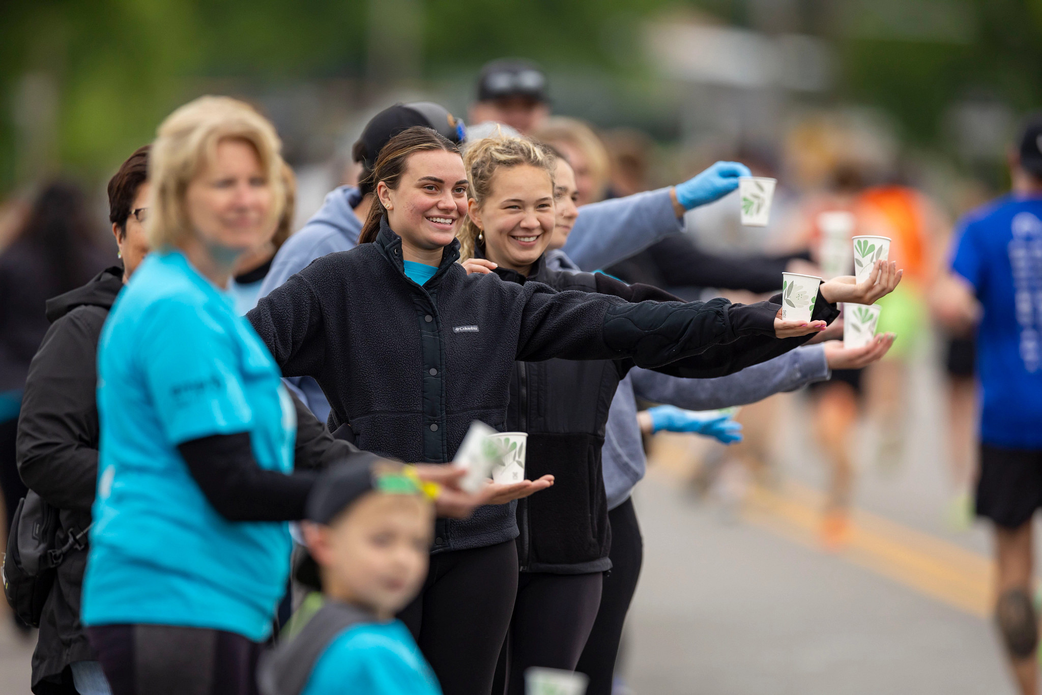 Volunteers handing out water at the 2025 Bellin Run