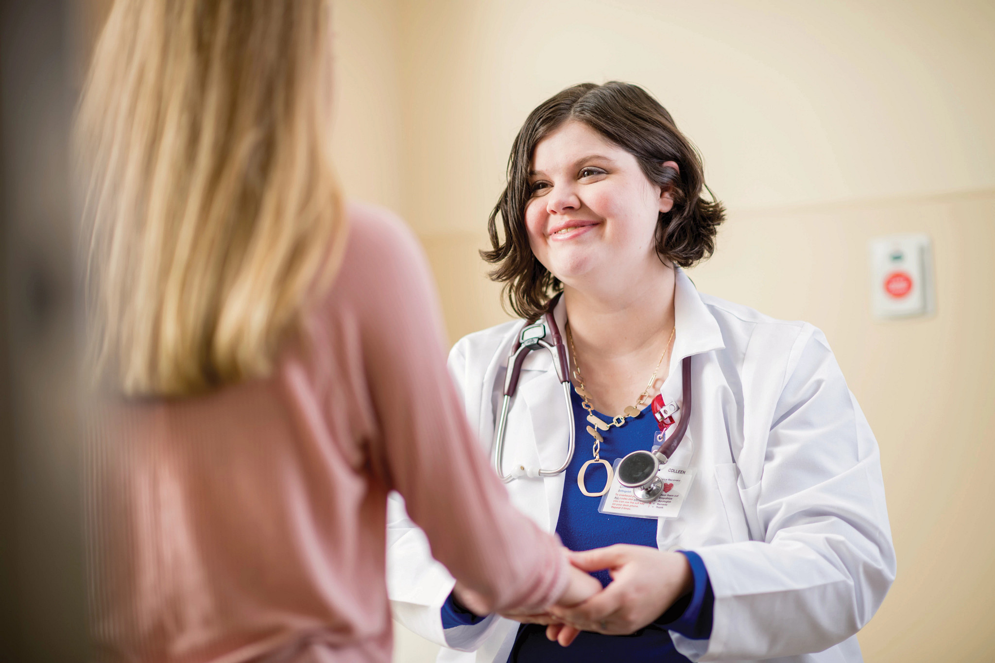 Adult female doctor examining a young teenage girl patient.