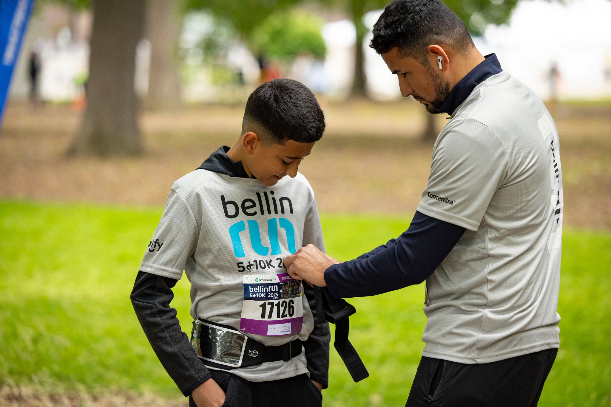 Father attaching race bib for his son at Bellin Run