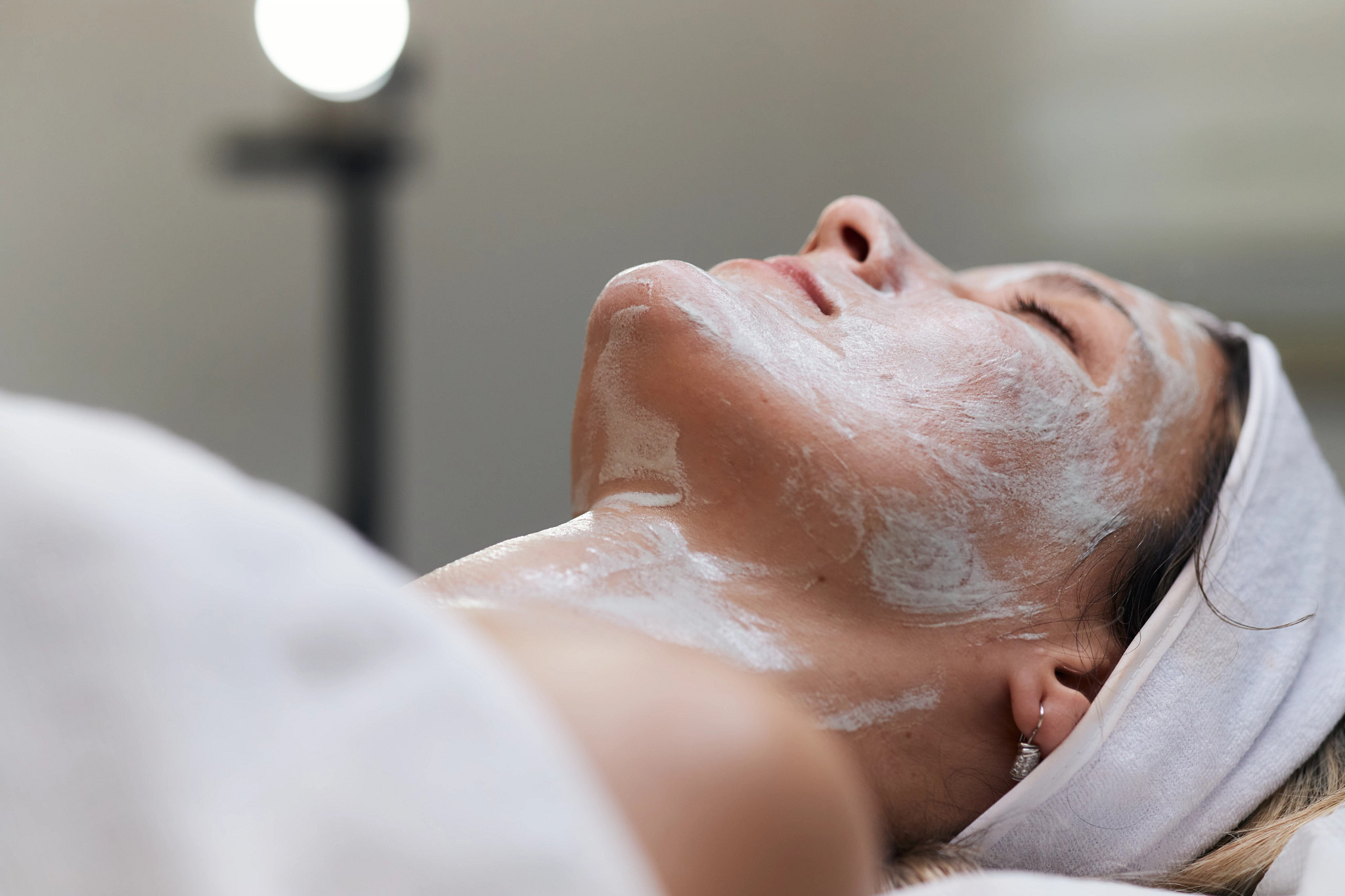 Woman enjoying a relaxing facial treatment as part of a luxury med spa package.