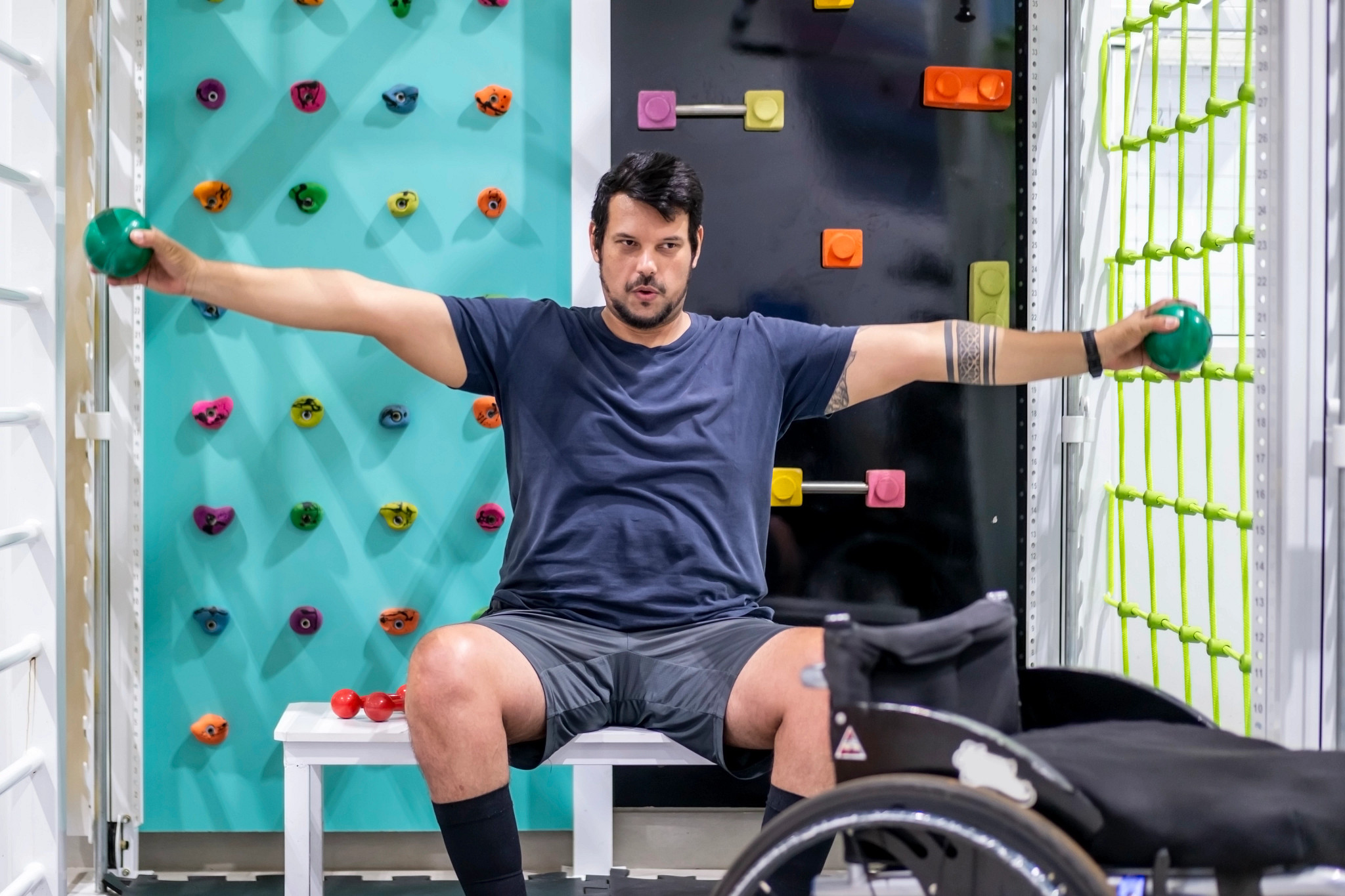 Man with wheelchair doing physical therapy.