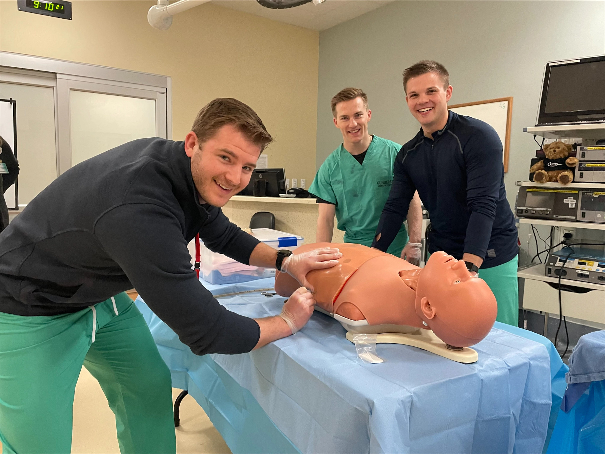 Medical students practicing on mannequin.