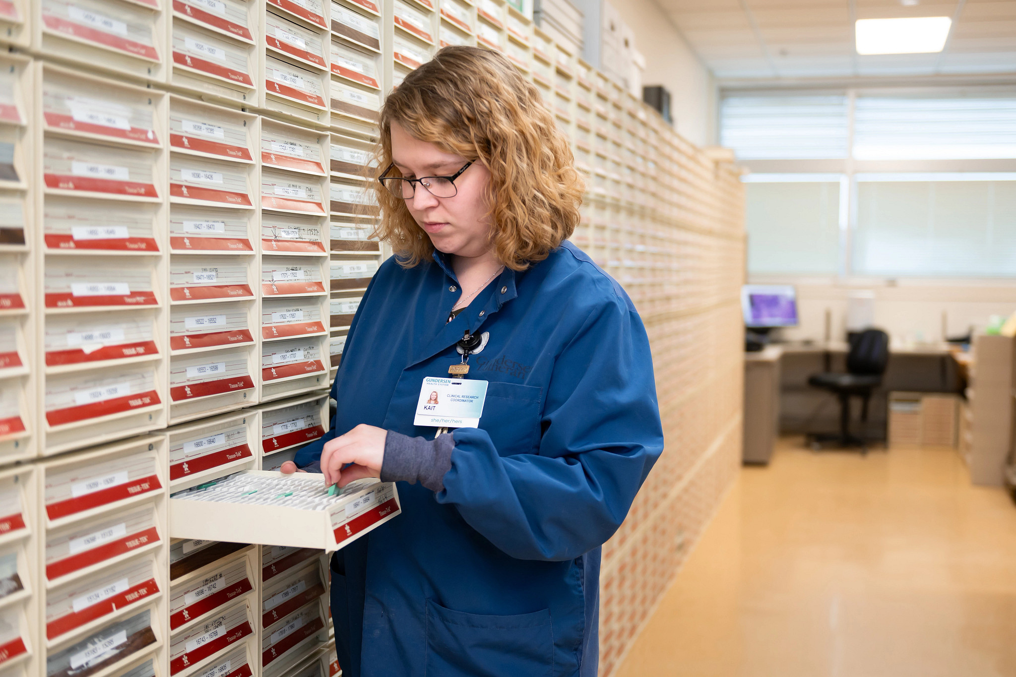 Researcher with specimen slide inside cancer Biobank.