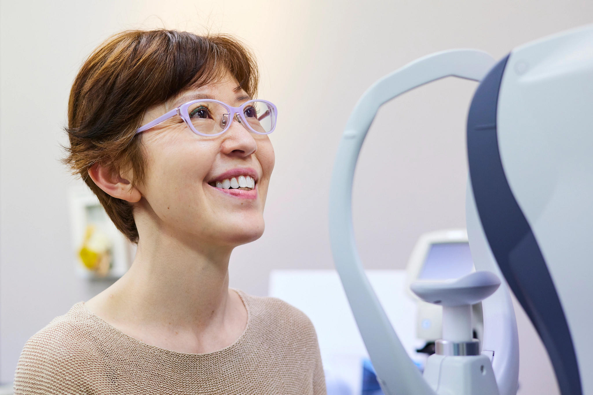 Woman getting her eyesight measured to buy new glasses
